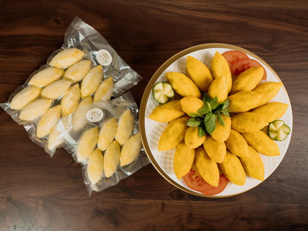 A sealed pack of frozen Kubba Halab beside a finished plate