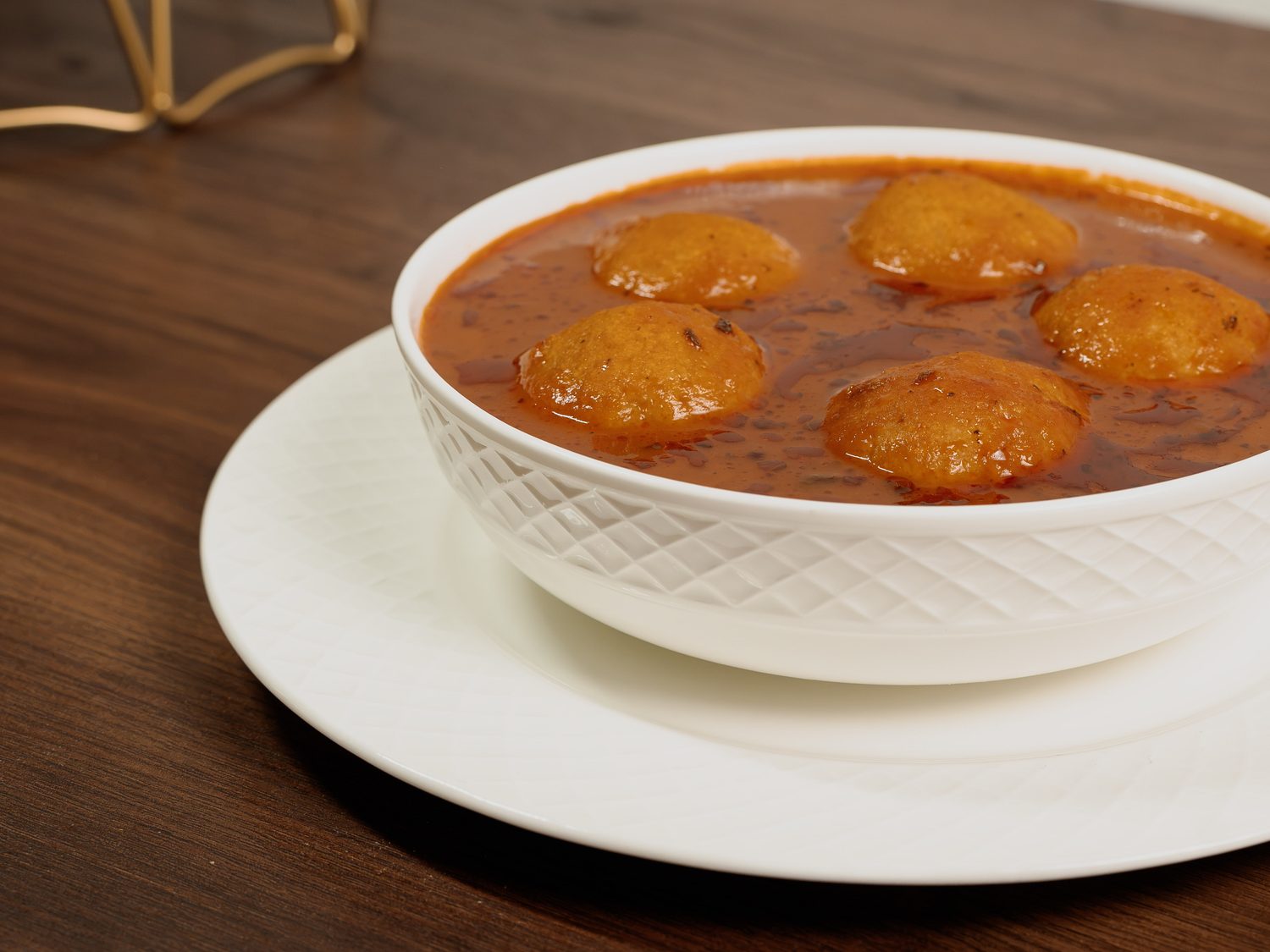 Kubba Saray served in a bowl of rich Iraqi tomato broth
